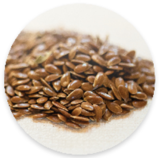 Parker Mountain Comfort Wraps are filled with flaxseed to provide a gentle and moist heat while also maintaining heat longer than other grains. In this image, Flax Seeds are displayed on a table.