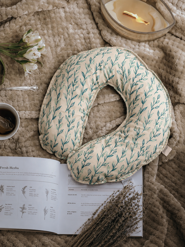 Seagrass weighted neck pillow with green botanical print flat lay