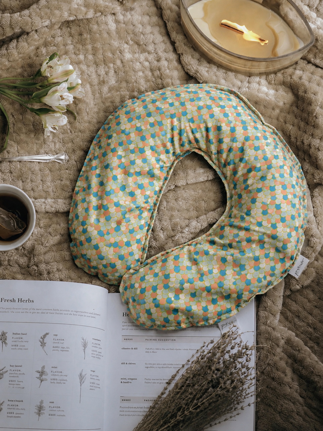 Mermaid weighted neck pillow with teal and coral scale print flat lay