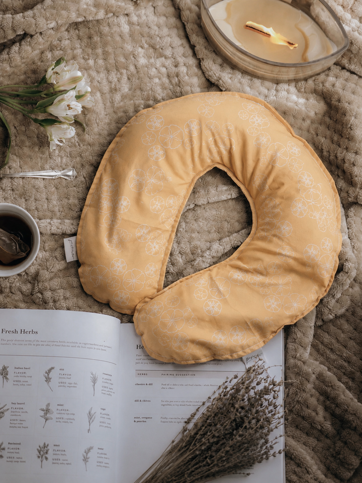 Treasures weighted neck pillow with golden sand dollar print flat lay